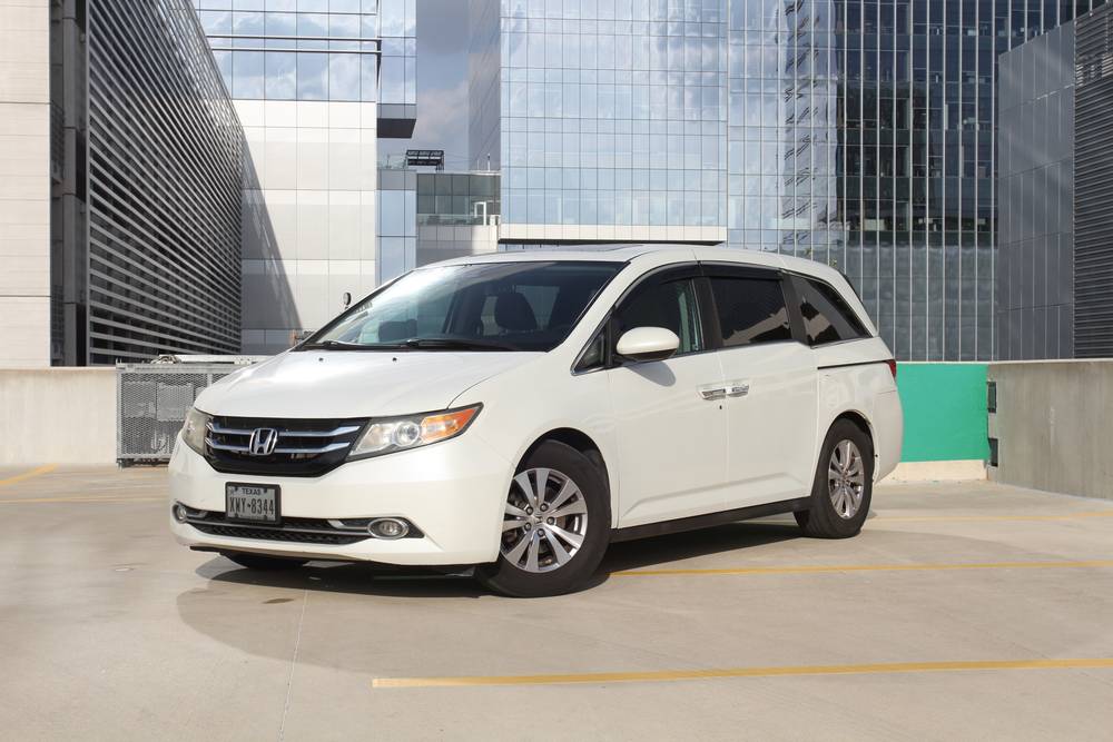 White Honda Odyssey parked on a rooftop deck