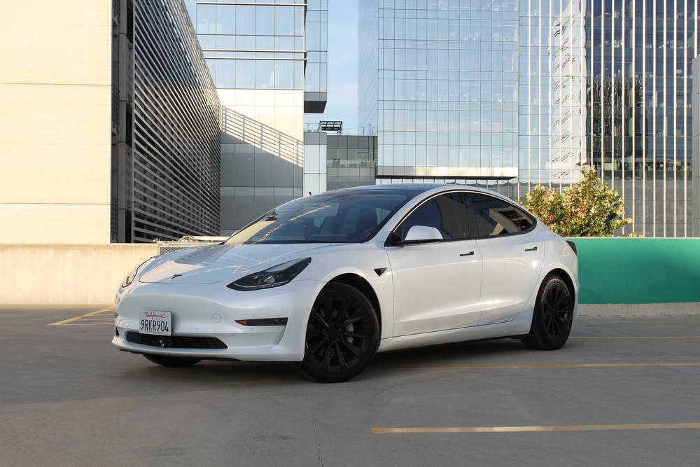 White Tesla Model 3 parked on a rooftop deck in Austin