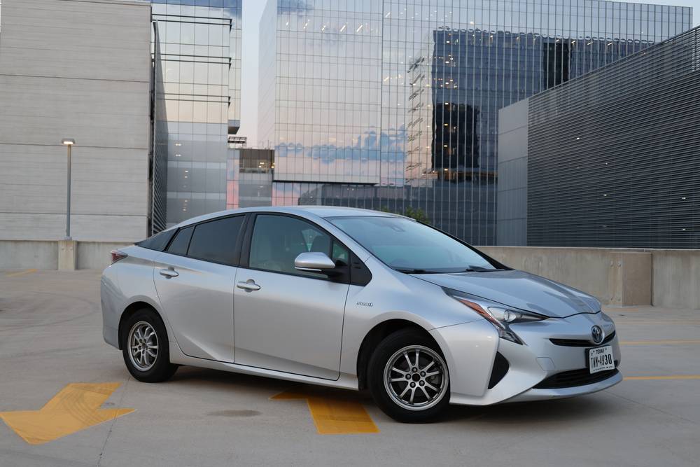 Silver Toyota Prius parked on a rooftop deck at dusk