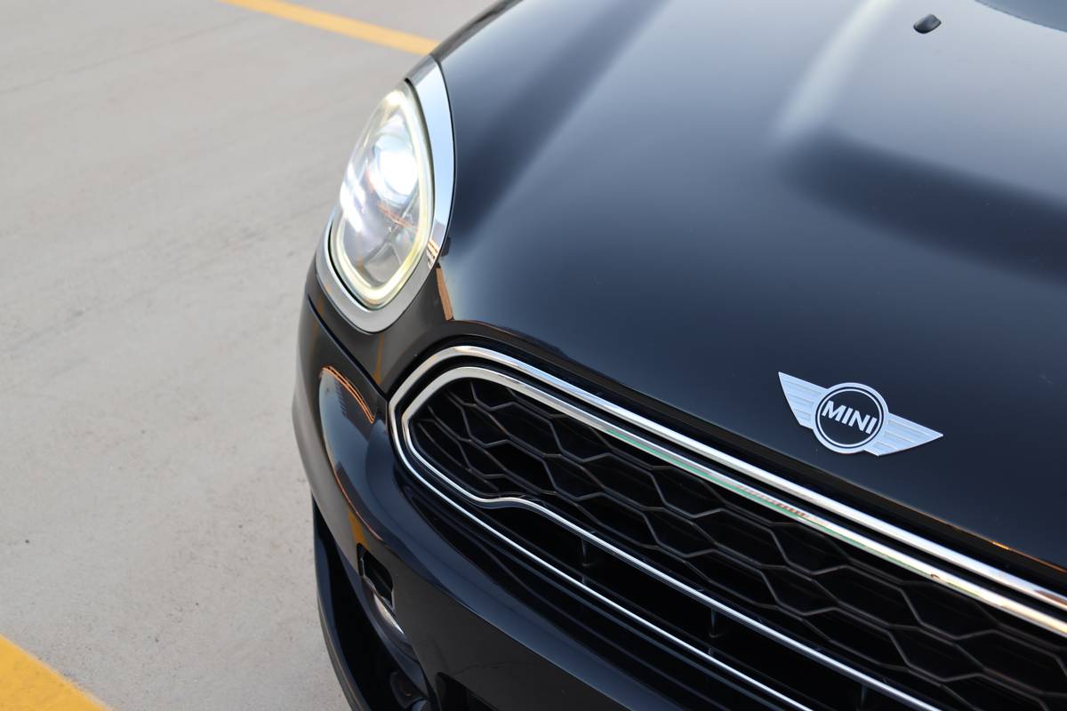 Headlight and grille detail of a black MINI Cooper