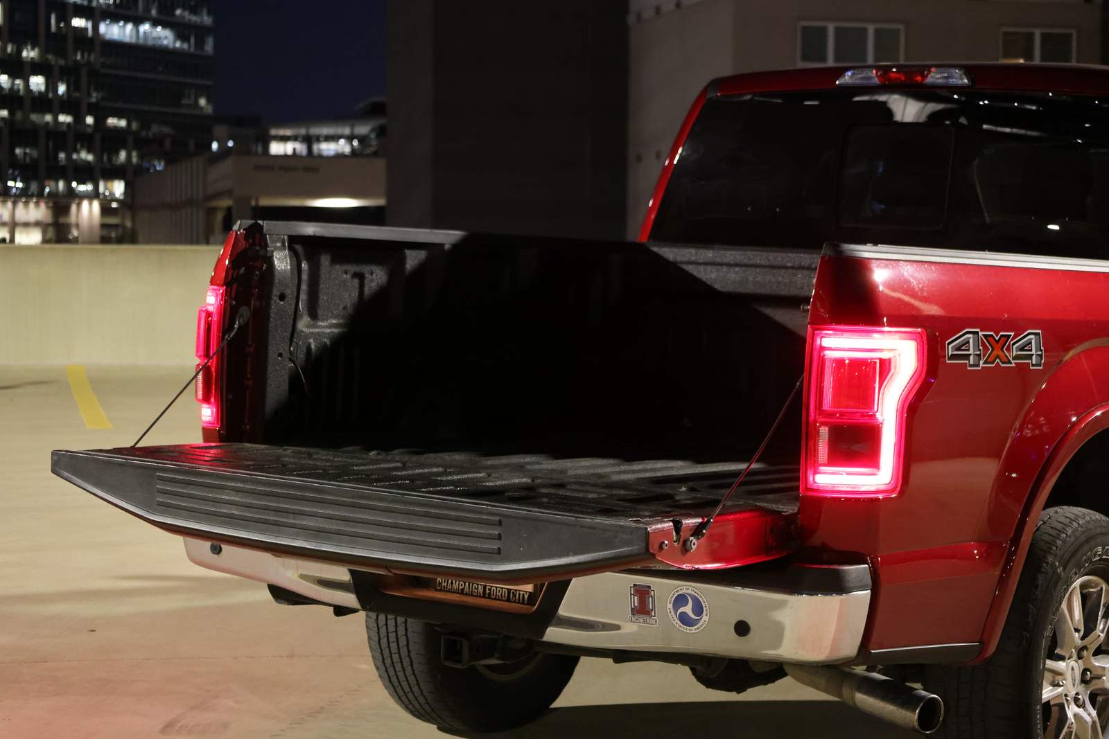 Ford F-150 with the tailgate down on a rooftop deck at night